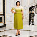 Black Nigerian woman wearing cream and chartreuse pleated dress