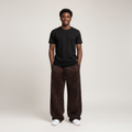 Model wearing brown leopard print baggy joggers with a black t-shirt