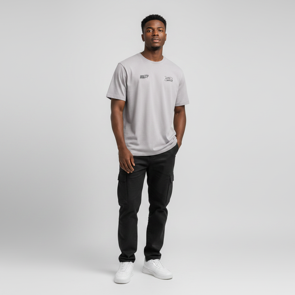 Young Nigerian male wearing light grey Reality Next World dual logo crew neck tee