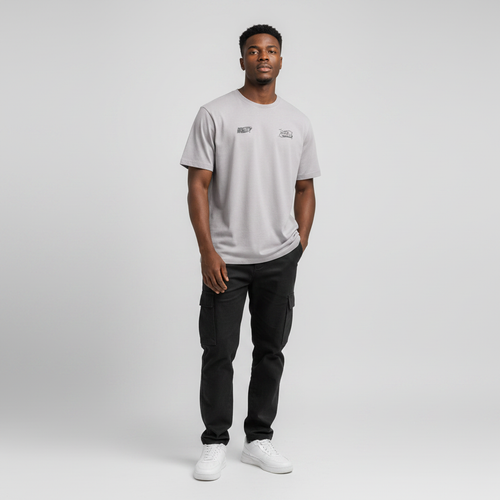 Young Nigerian male wearing light grey Reality Next World dual logo crew neck tee