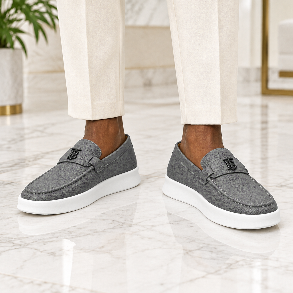 Man wearing grey pebbled monogram strap loafer sneakers