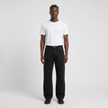 Full-body male model wearing black stud-detail jeans