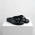 Men's black leather thong flip-flop sandals pair on white platform
