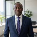 Nigerian man wearing blue plaid check necktie with white shirt and navy suit