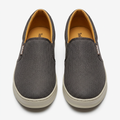 Straight-on charcoal-grey textured slip-on sneakers with light beige soles