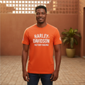 Nigerian male model wearing orange racing graphic tee, front view