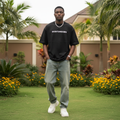 Nigerian male model wearing black Saintdreams faith graphic oversized tee – front view