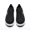 Straight-on black slip-on sneakers with textured uppers and white soles