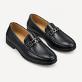 Black men's loafers with polished metal detail shown as a complete pair