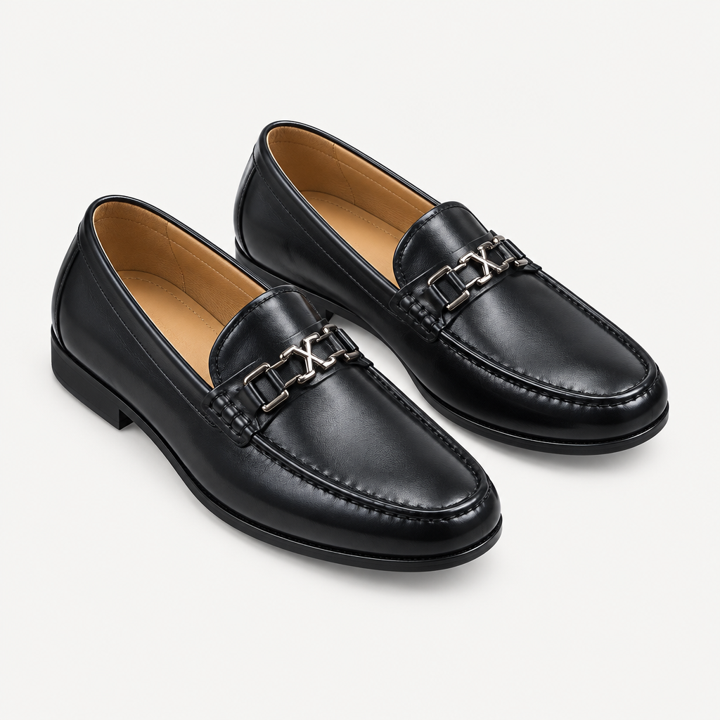 Black men's loafers with polished metal detail shown as a complete pair