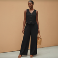 Model wearing black linen vest and wide-leg palazzo co-ord set
