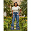 Nigerian female model wearing women's floral embroidered flare jeans in washed indigo