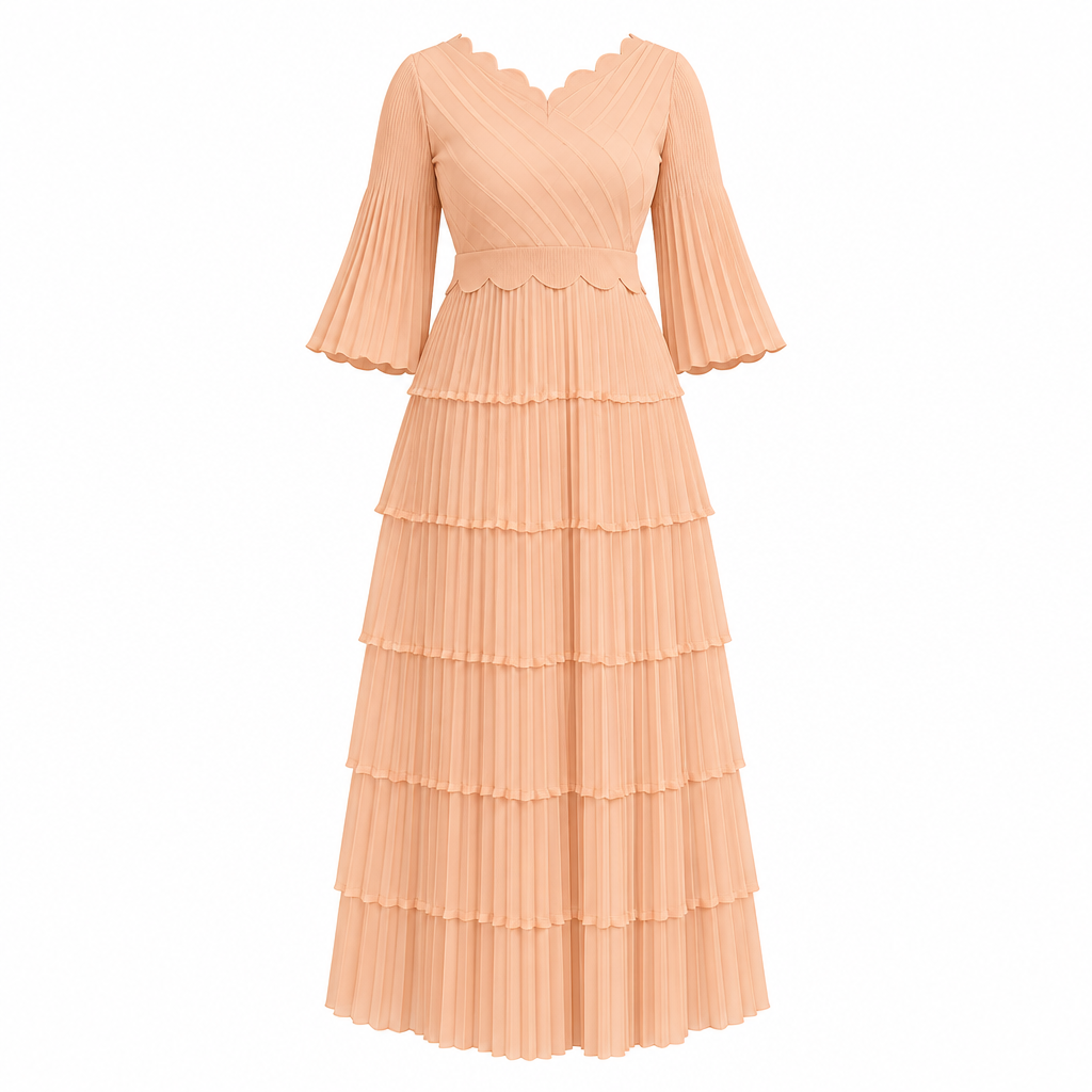 Soft peach scalloped tiered pleated dress on white background