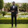 Nigerian male model wearing black double-breasted gold rhinestone lapel trim suit