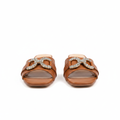 Pair of tan brown square-toe low block heel mule sandals with crystal buckle on white background