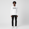 Man wearing the white bold slogan long sleeve tee