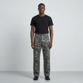 Full-body male model wearing green and grey camouflage trousers