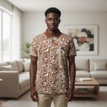Young Nigerian male model wearing brown abstract swirl print polo shirt, front view