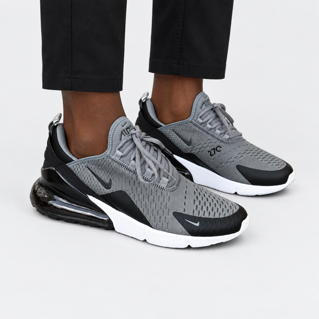 Adult wearing grey-and-black mesh lace-up sneakers