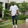 Nigerian male model wearing white oversized palm tree crest tee in casual minimal style