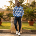 Nigerian male model wearing royal blue diamond plaid oversized knit sweater — full body street style