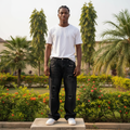 Nigerian male model full body wearing men's black washed floral embroidered wide-leg baggy denim jeans