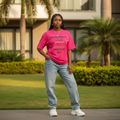 Nigerian female model wearing hot pink stacked text graphic tee – front view