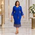 Black Nigerian woman wearing blue belted lace-flounce occasion dress