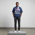Nigerian male model wearing navy blue cartoon graphic short-sleeved shirt, front view
