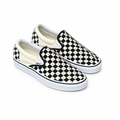 Black-and-white studded checkerboard slip-on sneakers on a white background
