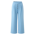 Light-blue wide-leg drawstring trousers with three silver-tone front details on an invisible mannequin
