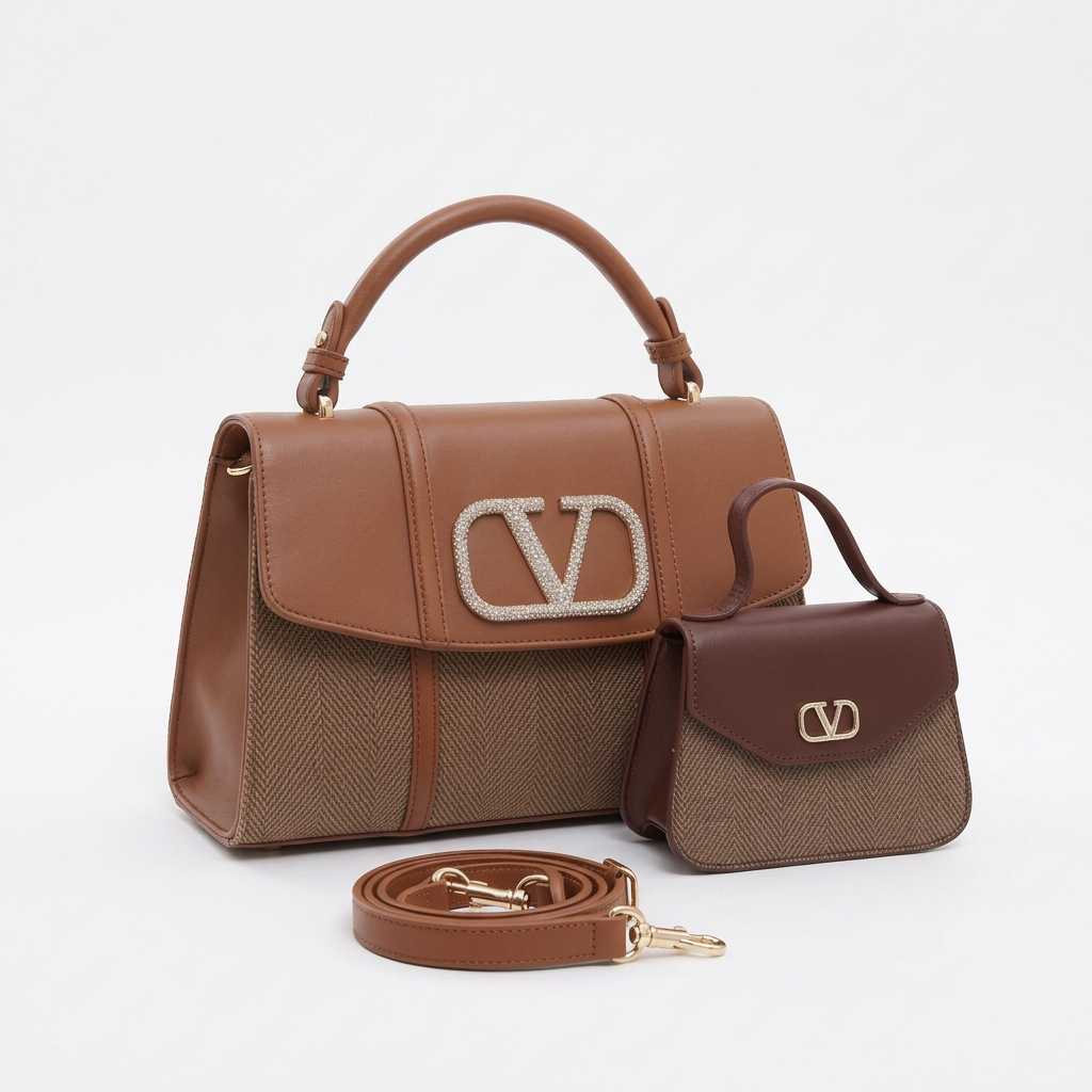Brown patterned-panel top-handle handbag with sparkling ornament beside smaller bag and strap