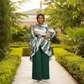 Nigerian female model wearing green abstract print top and forest green pleated palazzo trousers set
