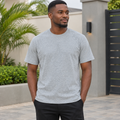 Black Nigerian adult model wearing a grey heather basic T-shirt