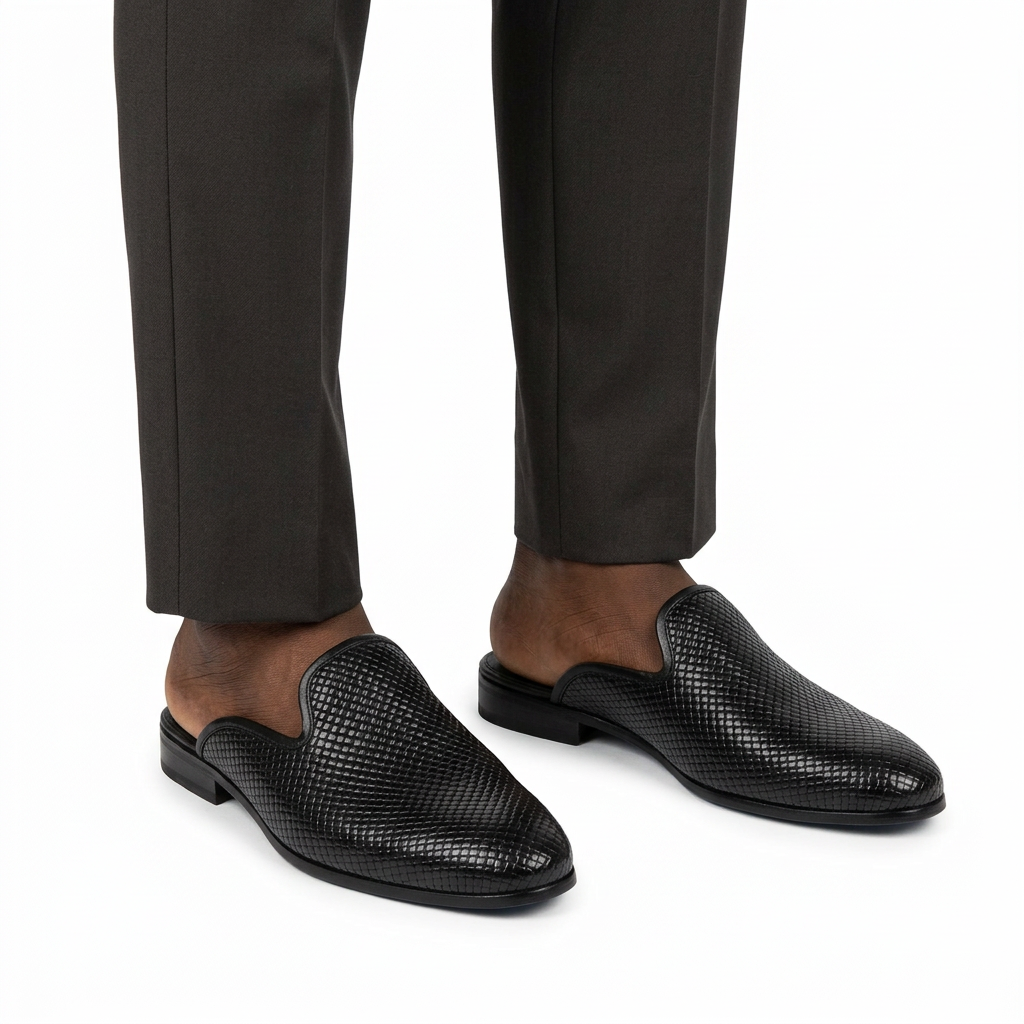 Men’s black woven-textured mule shoes worn with tailored trousers