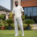 Nigerian male model wearing light grey ribbed wide-leg jogger pants