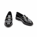 Black patent leather loafer with silver horsebit bar detail — clean pair product shot