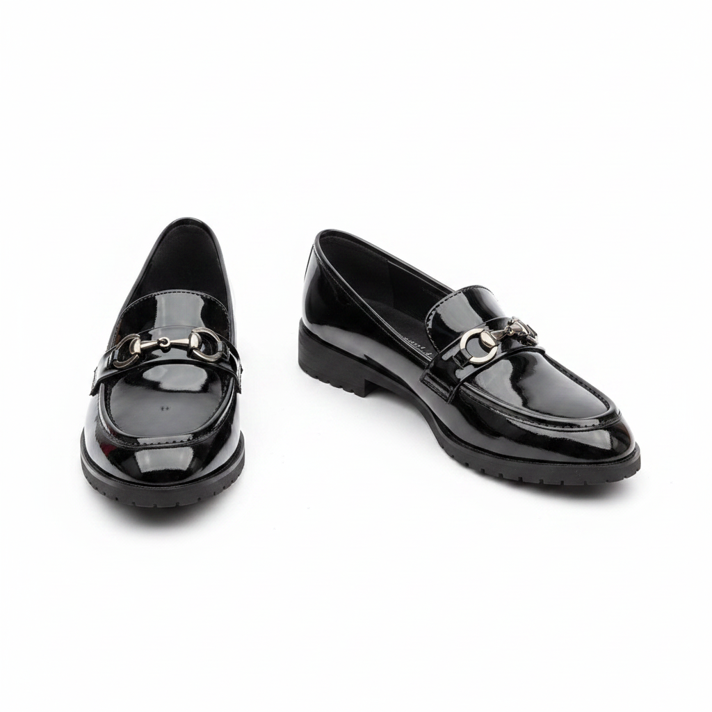 Black patent leather loafer with silver horsebit bar detail — clean pair product shot
