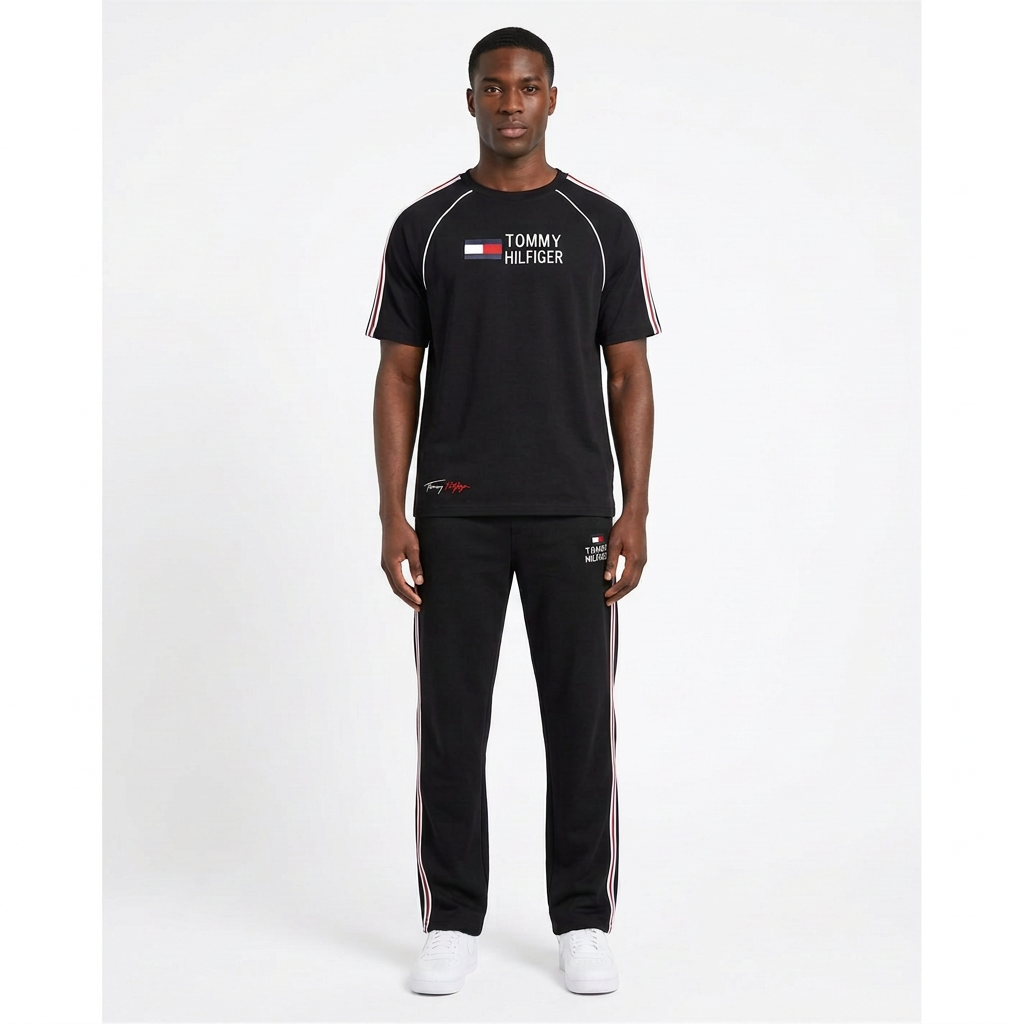 Adult Black model wearing a black T-shirt and trouser set with red-and-white side stripes