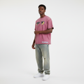 Young Nigerian male wearing dusty rose Pet Sematary cat eyes graphic oversized tee