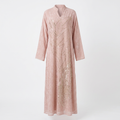 Blush pink leaf-motif embellished abaya on an invisible mannequin against white