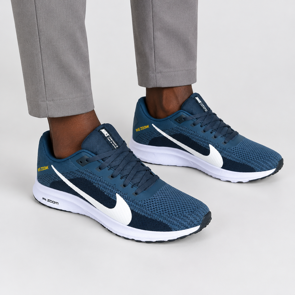 Blue mesh lace-up sneakers worn with neutral trousers