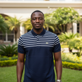 Nigerian male model wearing navy striped yoke polo shirt in garden setting