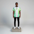Nigerian male model wearing white neon green flame football jersey on concrete plinth