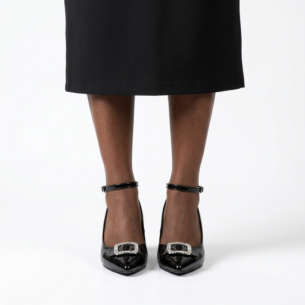 Adult woman standing with feet together wearing black jeweled-buckle ankle-strap block heels