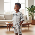 Young Nigerian boy wearing Heroes matching grey graphic tee and shorts set