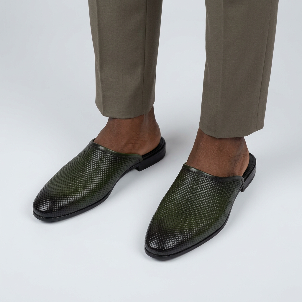 Dark green woven-texture mules worn by an adult Black model