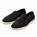 Pair of black suede summer walk loafers on white background