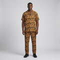 Nigerian man wearing gold-brown abstract-print shirt and trouser set