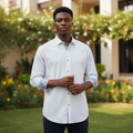 Young Nigerian male wearing crisp white long sleeve dress shirt with floral contrast inner cuffs and collar